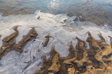 Hoarfrost and fresh powder snow in winter, on a wild, beautiful, river bank