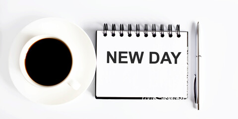 Business NEW DAY . Spiral notebook with text on the white background with coffee