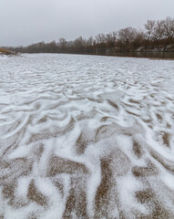 Hoarfrost and fresh powder snow in winter, on a wild, beautiful, river bank