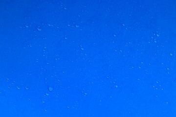 Water drops on a blue background, freshness. Texture with water drops, rain. The photo