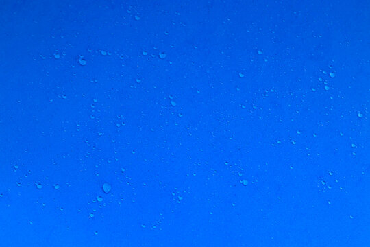 Water drops on a blue background, freshness. Texture with water drops, rain. The photo