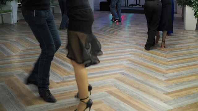 Argentine tango, milonga. Feet of dancers dancing Argentine tango at a party. Bokeh, Novosibirsk. Siberia.