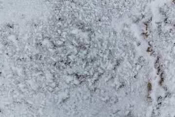 Abstract shapes with sand dunes covered by fresh powder snow, in a wild river bed, in winter