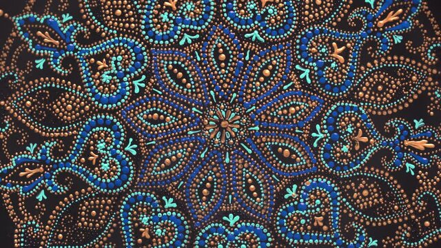 Decorative ceramic plate with black, blue and golden colors, painted plate on background, closeup, top view, rotate. Decorative porcelain plate painted with acrylic paints, handwork, dot painting