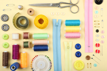 different sewing accessories on the table. Threads, needles, pins, fabric and sewing scissors close up
