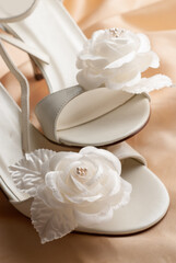 Pair of beautiful bridal wedding femail shoes and roses decoration in it