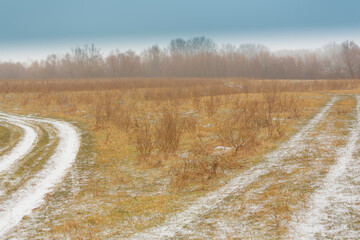 Beautiful country road covered with fresh snow and frost, in winter, in remote rural location