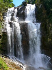 Fototapeta premium Indian subcontinent, Sri Lanka (Ceylon), Nuwara Eliya, waterfall and tea plantation