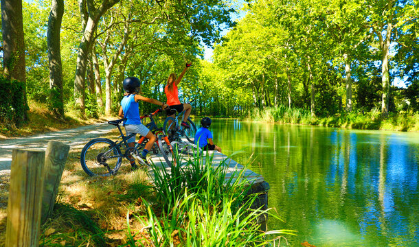 Happy Family Biking Along Of River- Canal Du Midi-France