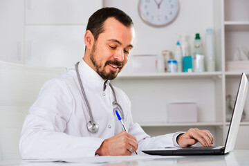 Satisfied male doctor having a productive day helping in his office