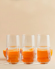 Oranges for glasses of water. Distorted image of water. Art concept, trending photo. Minimalism. Copy space.