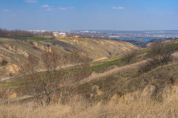 Fototapeta na wymiar Spring landscape with soil erosion in outskirts of Dnepr city, Ukraine