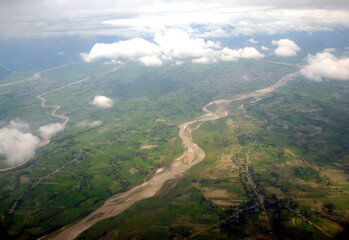 A spectacular aerial view of villages deviated with Mechi river with clouds as seen from flight...