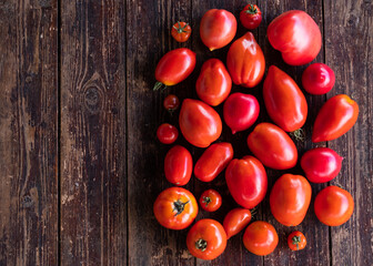 Delicious red tomatoes. Abstract background. Tomato on the wooden table.. Summer tray market agriculture farm full of organic vegetables
