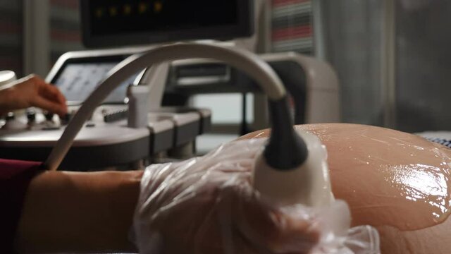 Obstetric Ultrasound scans. Ultrasound investigation of pregnant woman. Pregnancy and Healthcare concept. Doctor doing 3d ultrasound on belly in clinic. Process of fetus ultrasonography. 4 k video