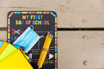 First day of school chalkboard with a face mask