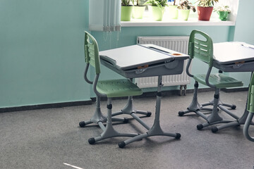 Moderd school smart classroom without young student.View of elementary class room no kid or teacher with chairs and deskd tables in campus. Primary school bags.