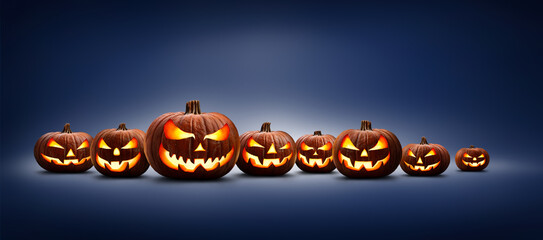 Eight halloween, Jack O Lanterns, with evil spooky eyes and faces isolated against a blue lit background.
