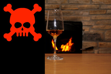 in front of the fireplace, in which firewood burns with a bright flame, there is one glass of wine, the sign is skull