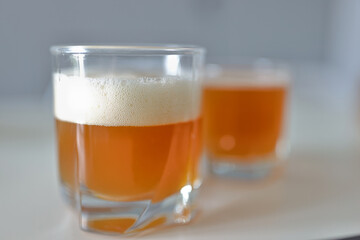 Glass with an orange drink and froth. Types of soft drinks concept