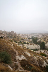 Fototapeta na wymiar Natural landscape of Cappadocia, semi-arid region in central Turkey known for its distinctive fairy chimneys, tall cone-shaped rock formations clustered in Monks Valley, Göreme and elsewhere- Kayseri