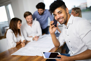 Team of architects working on construction plans in office
