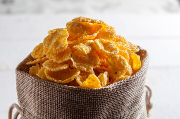 Cornflakes are in a linen bag. A full bag of cornflakes.