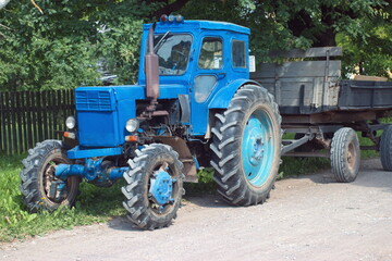 Working blue tractor with trailer