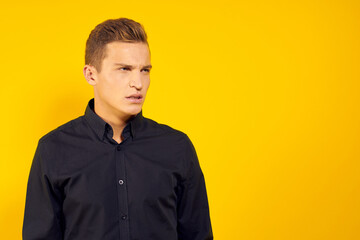 Fototapeta premium emotional man in black shirt lifestyle yellow isolated background