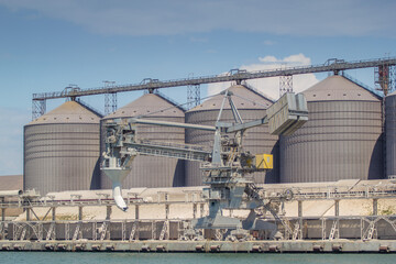Shiploader at the berth of the sea grain terminal, mooring gallery, silos. General view of the grain terminal.