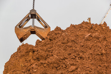 Understood open gantry crane grab pours bulk cargo onto a stack