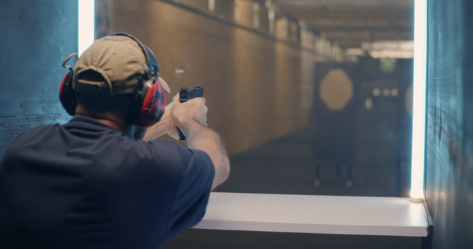 Professional shooter firing at target