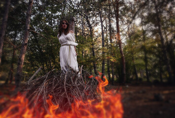 Fototapeta na wymiar Beautiful mystery gothic woman in long white dress in autumn forest.