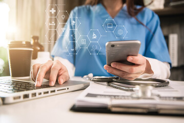 Medicine doctor hand working with modern digital smartphone and computer interface as medical...