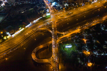 Fototapeta na wymiar Aerial view of freeway interchange offramp and bridge over canal with traffic from high symmetrical angle