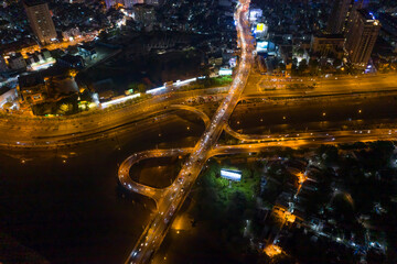 Fototapeta na wymiar Aerial view of freeway interchange offramp and bridge over canal with traffic from medium height and angle