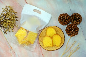 Crispy butter and sugar toasts served on wooden tray surrounded by decorative elements.