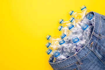 Recycle technology of plastic bottle to make clothes. Top view old water bottle and blue short...