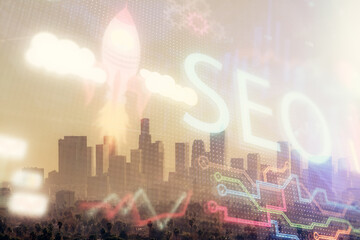 SEO hologram on city view with skyscrapers background double exposure. Search optimization concept.