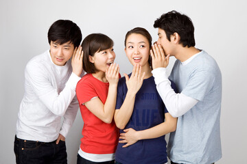 young man whispering to his friends