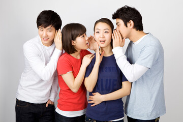 young man whispering to his friends