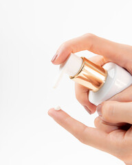 Woman holding bottle of lotion applying on her finger. Cosmetic or medical treatment. Sanitizer anti-virus. Close up front view