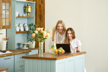 Two young women making online shopping, finding and discussing goods