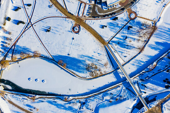 Big city after heavy snofall, aerial top landscape. Winter patterns in town. Cold sunny weather concept