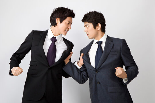 Two Young Businessmen Fighting