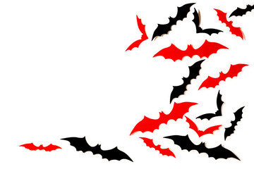 Fototapeta na wymiar Black and red paper cut bats flying over white background. Halloween decoration background with copy space.