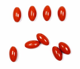 Red pills, medical capsules isolated on white background, top view