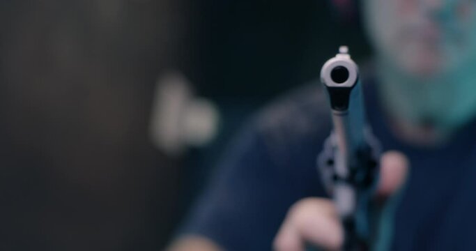 Unrecognizable man reloading revolver in shooting range