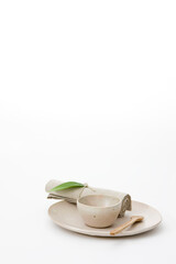 bowl with spoon and napkin on plate