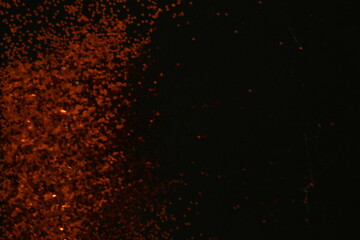 Fototapeta na wymiar Abstract dark orange dots black background for texture